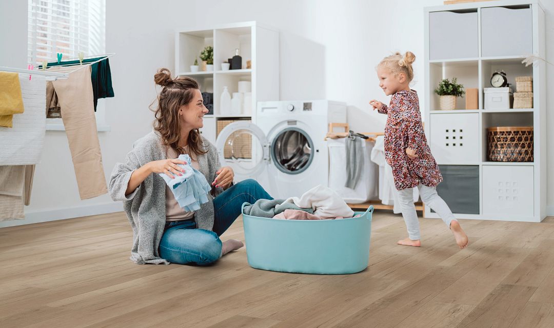 laundry mother and child on laundry room floor warm grey vinyl floor